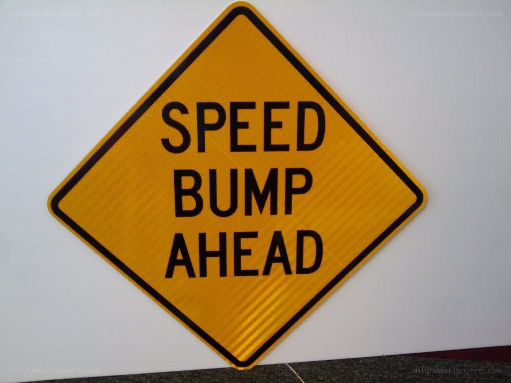 Speed bump ahead warning sign