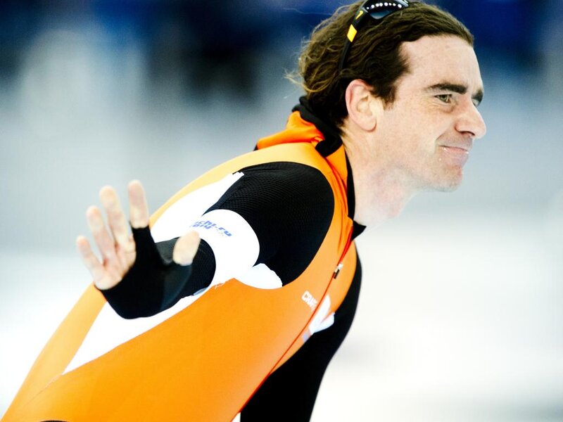 Speed Skater in Orange Suit — Focused, Photograph, Skating Rink