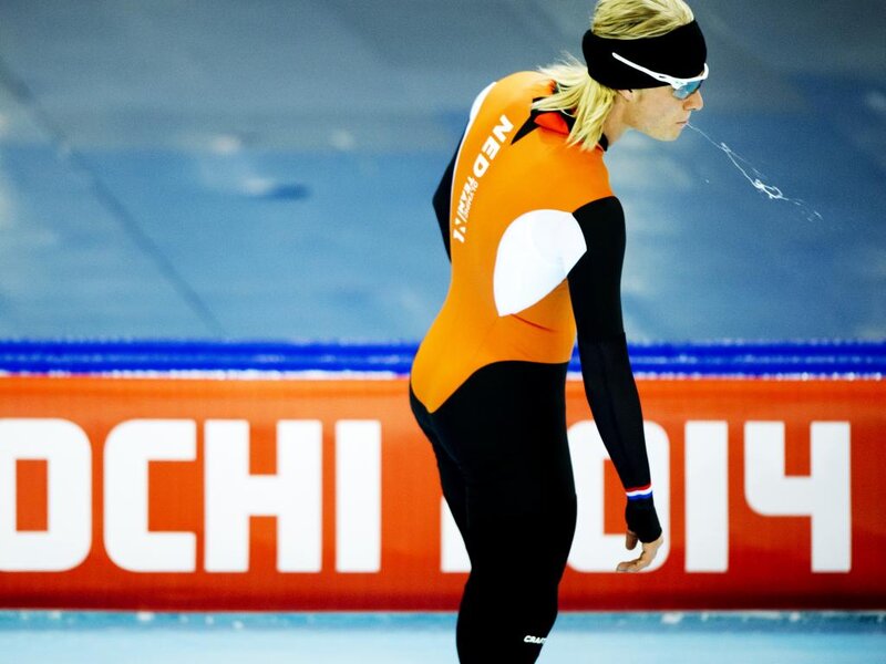 Speed Skater on Ice — Orange, Focused, Photograph, Ice Rink