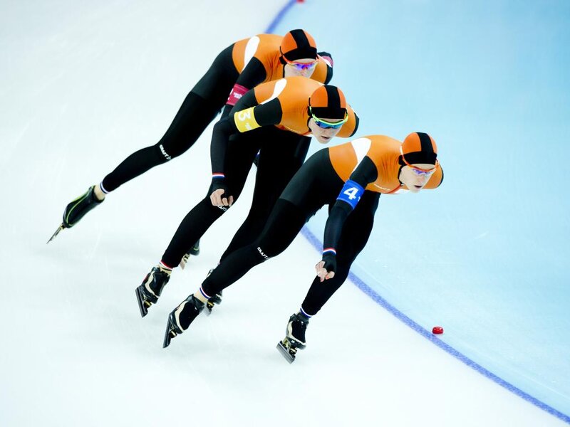 Speed Skaters in Action — Orange