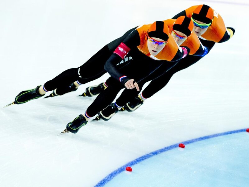 Speed Skaters in Motion — Orange
