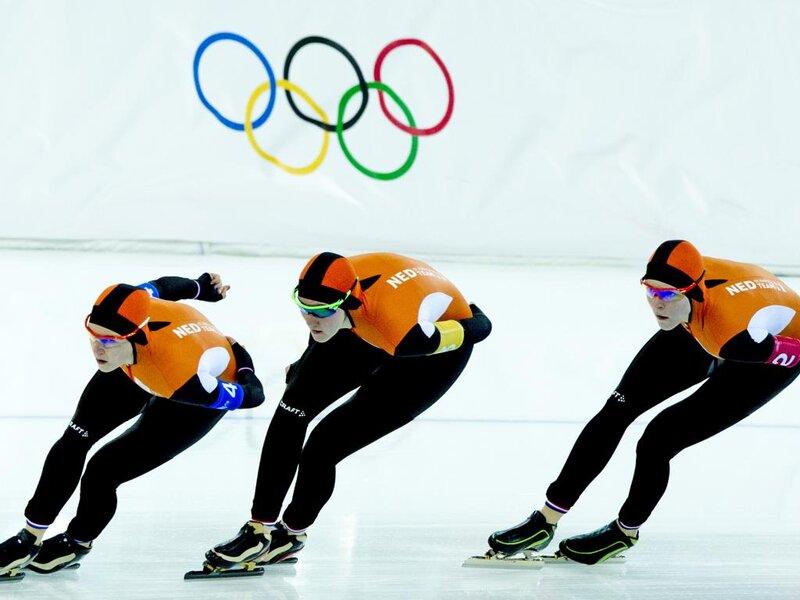 Speed Skaters on Ice — Orange, Competitive, Photograph, Olympic Rings