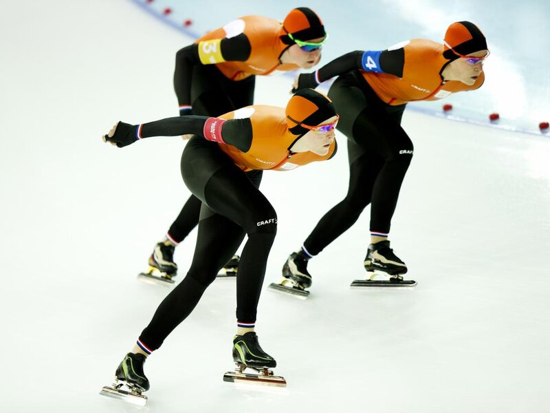 Speed Skaters on Ice — Orange, Focused