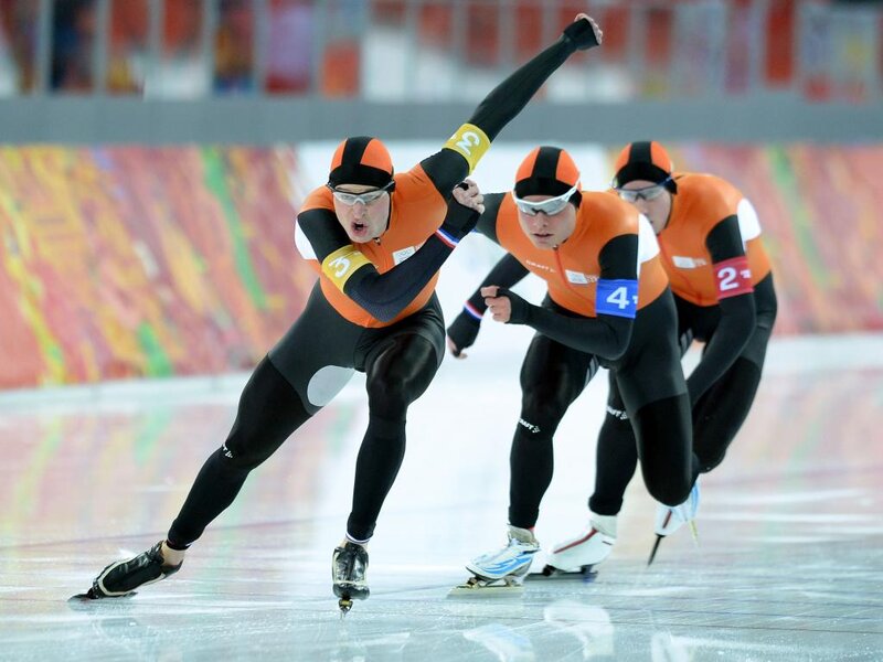Speed Skaters on Ice — Orange, Intense, Photograph