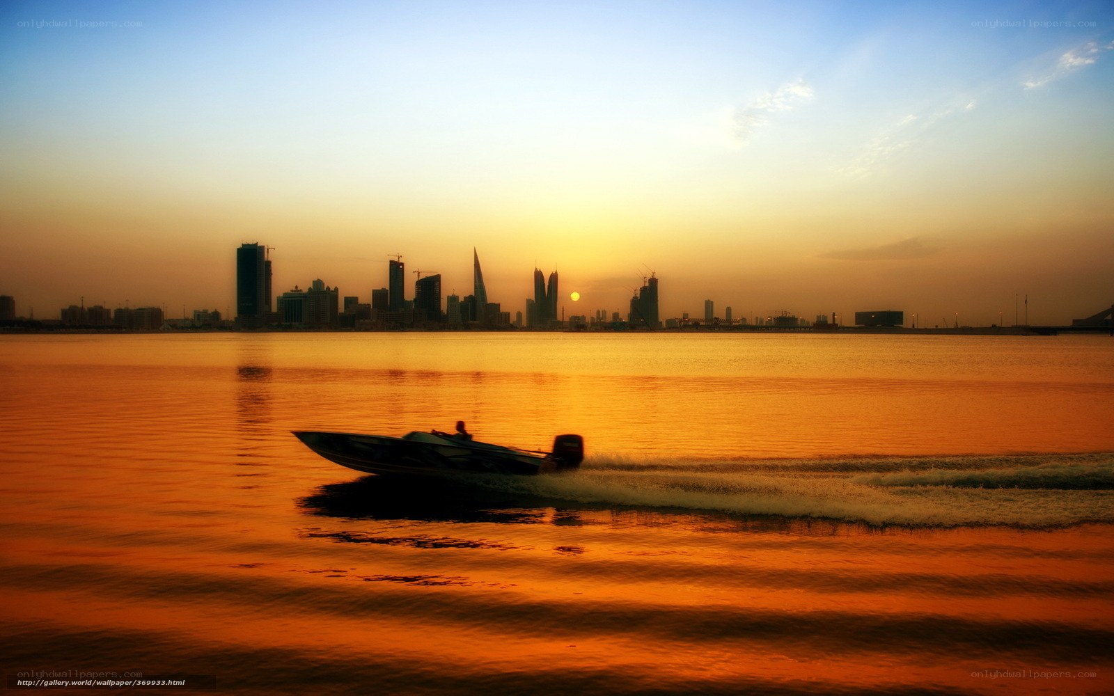 Speedboat at sunset over city