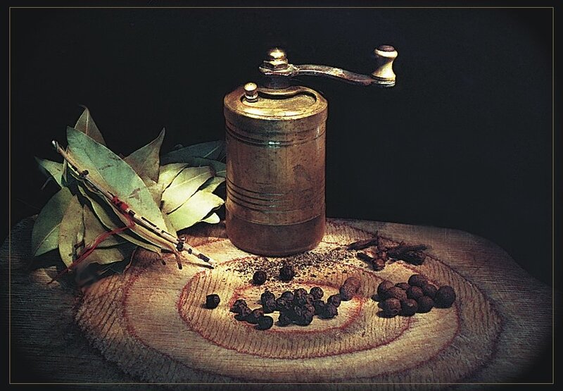 Spices and grinder on wood
