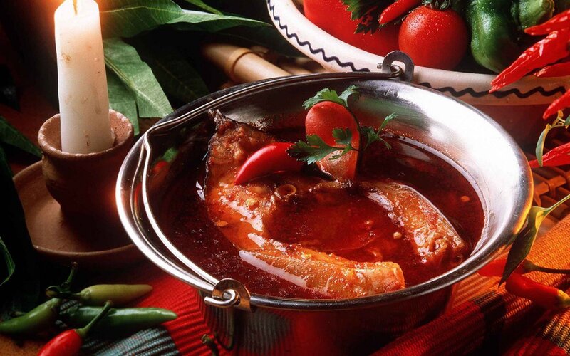 Spicy fish stew in a metal pot