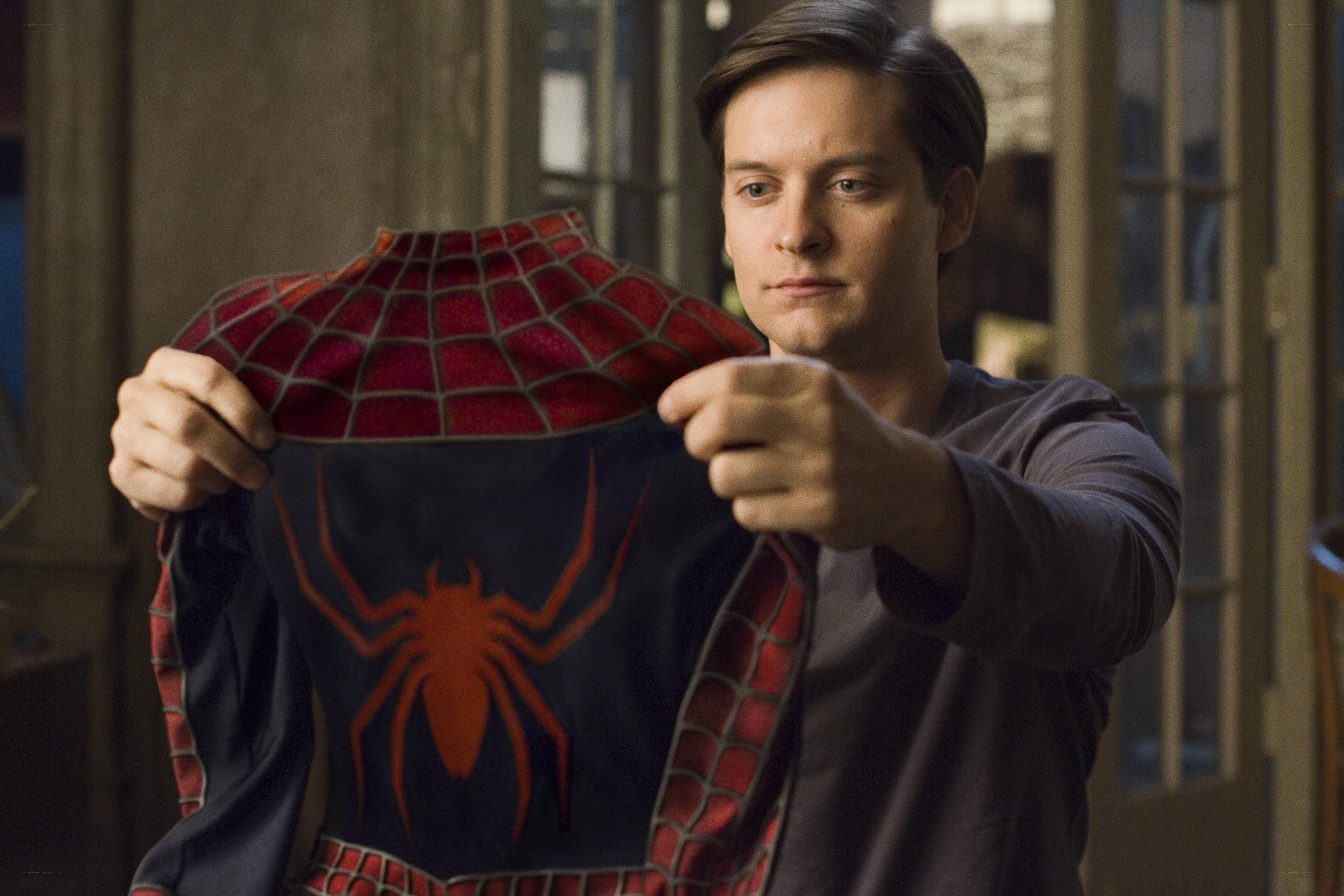 Spider-Man costume held by Peter Parker