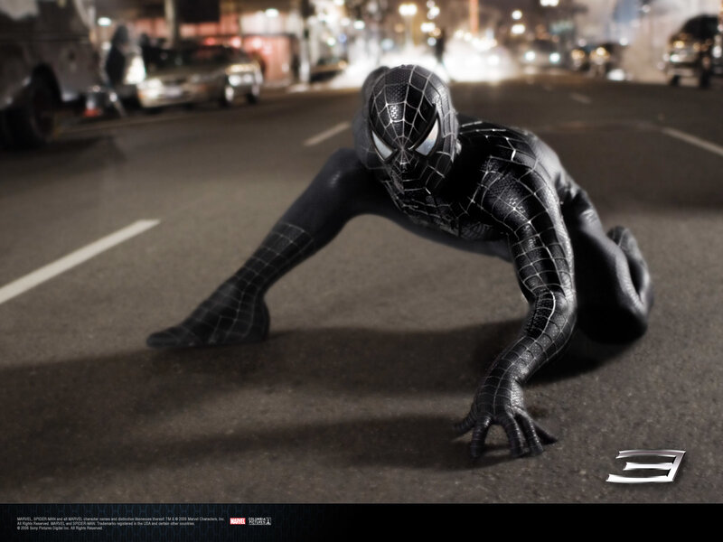 Spider-Man in black suit on street