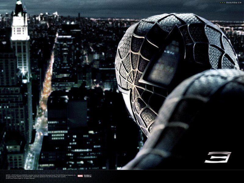 Spider-Man in black suit overlooking city