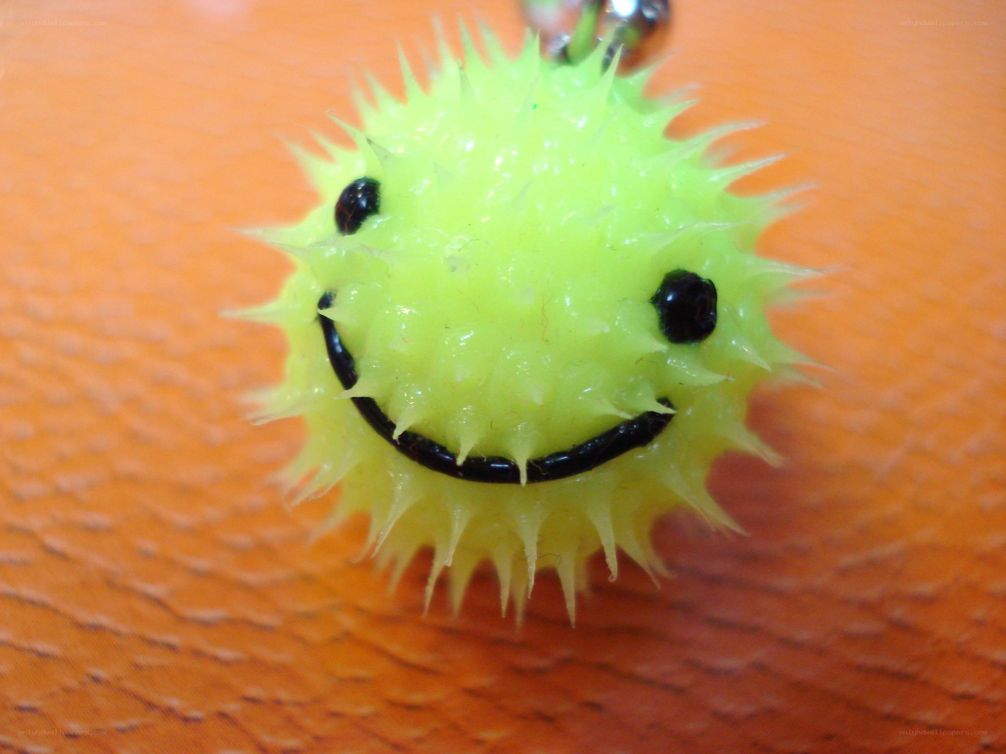 spiky green smiley charm