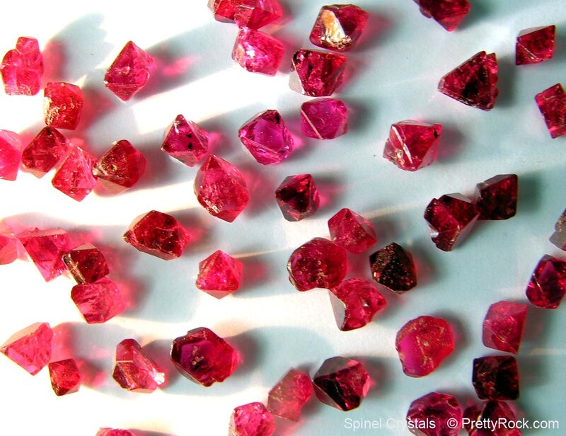 Spinel crystals on white surface