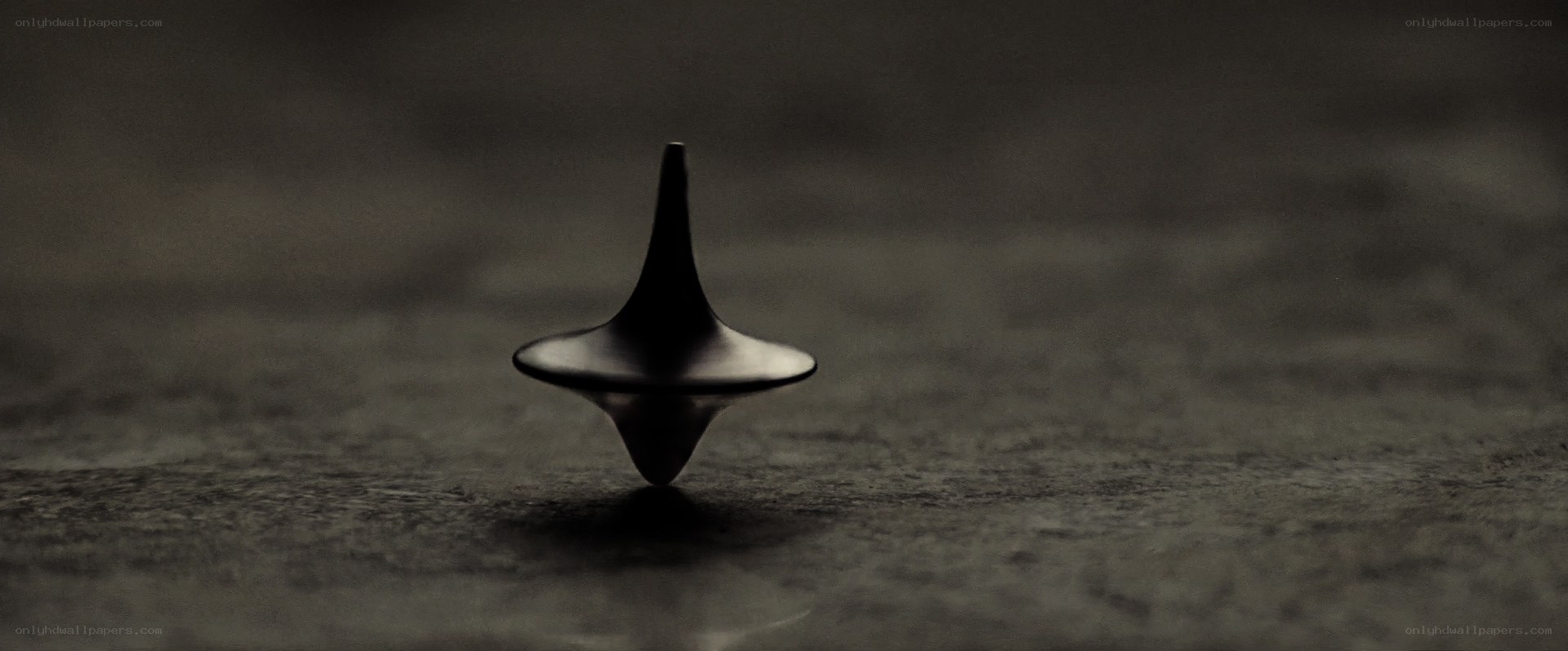 spinning top on dark surface