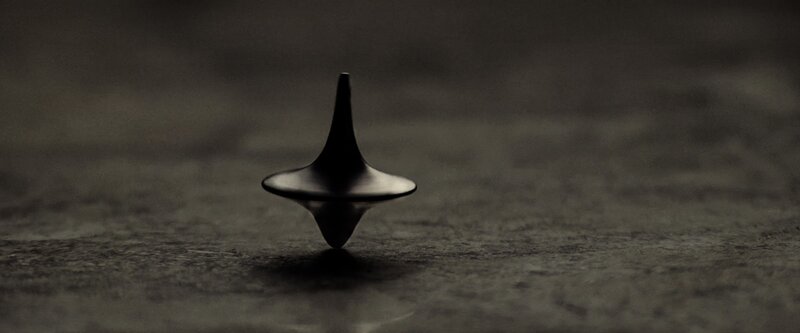 Spinning Top on Surface — Black