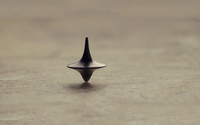 Spinning Top on Surface — Gray