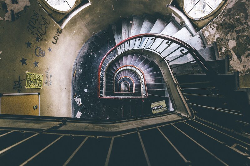 Spiral Staircase in Abandoned Building — Gray, Dramatic