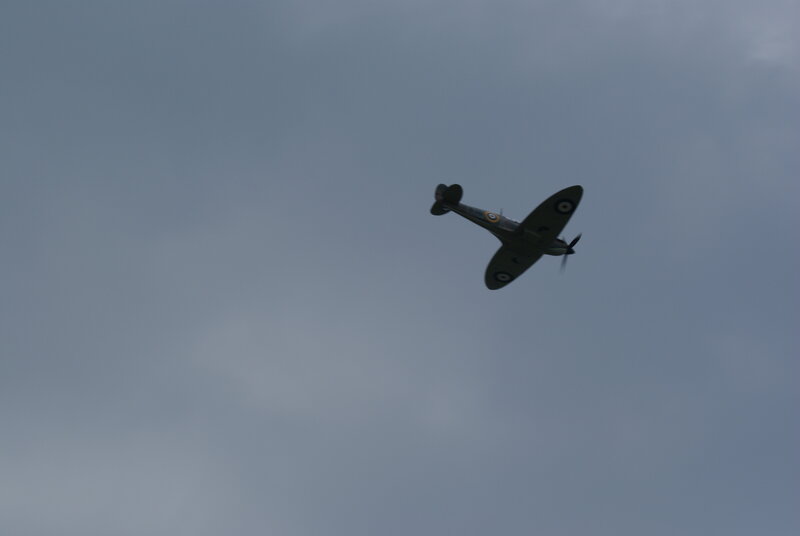 Spitfire Airplane in Flight — Gray, Overcast, Photograph