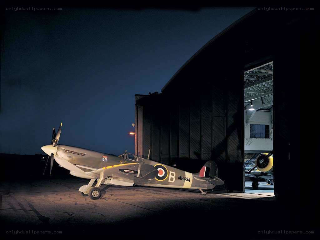 Spitfire at night by hangar