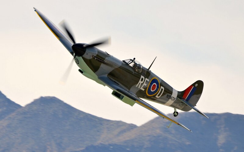 Spitfire Fighter Plane — Gray, Dynamic, Afternoon, Photograph, Mountains
