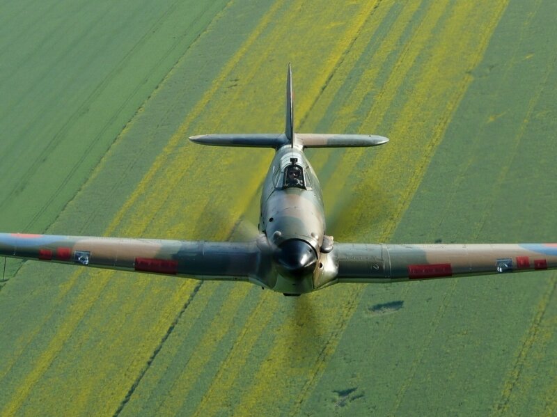 Spitfire flying over fields
