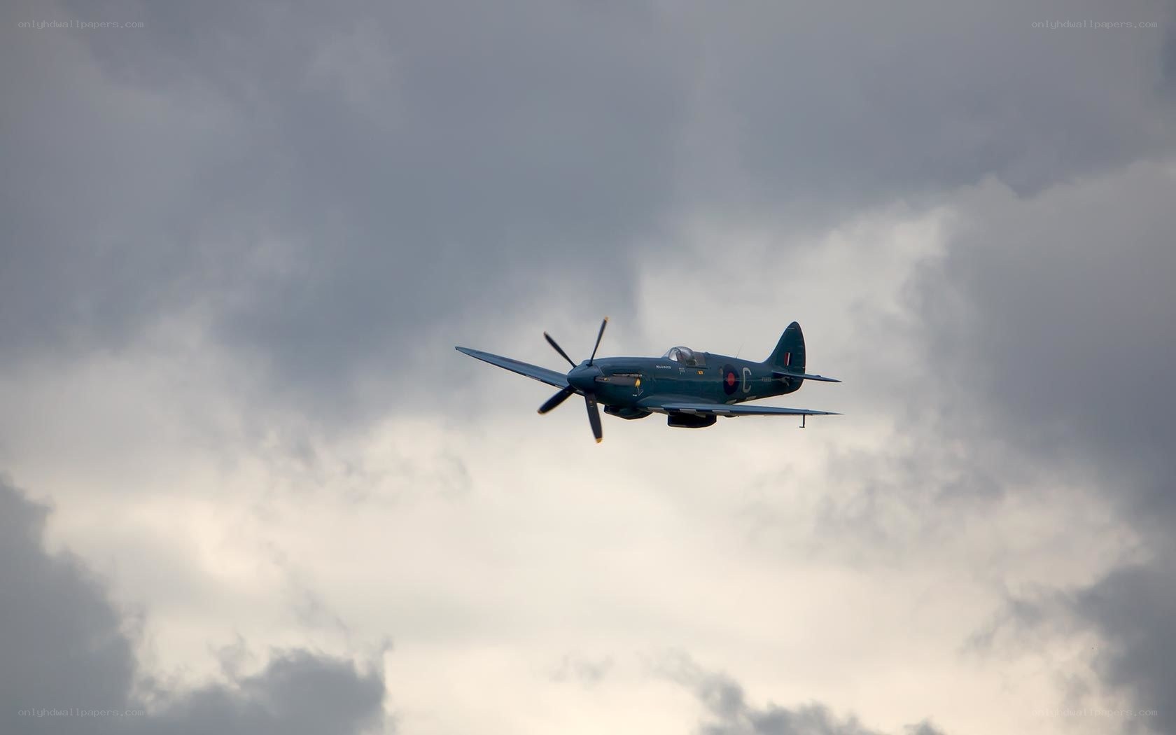 Spitfire in cloudy sky