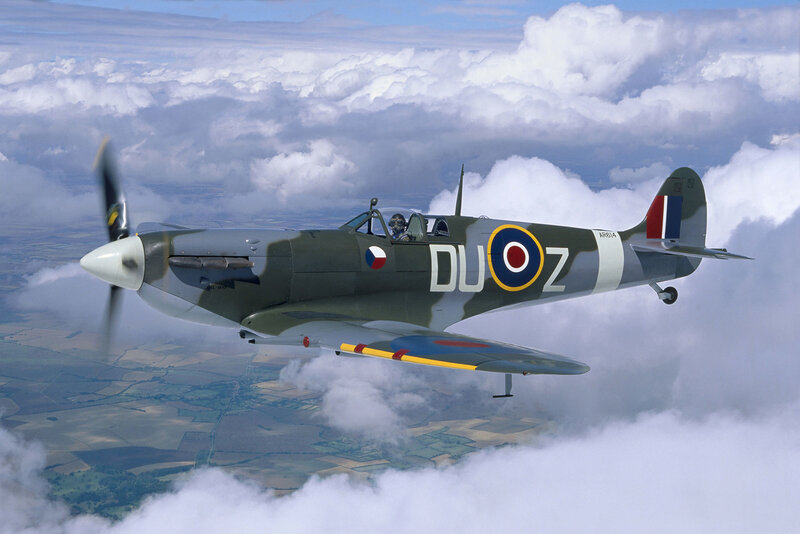 Spitfire in flight above clouds