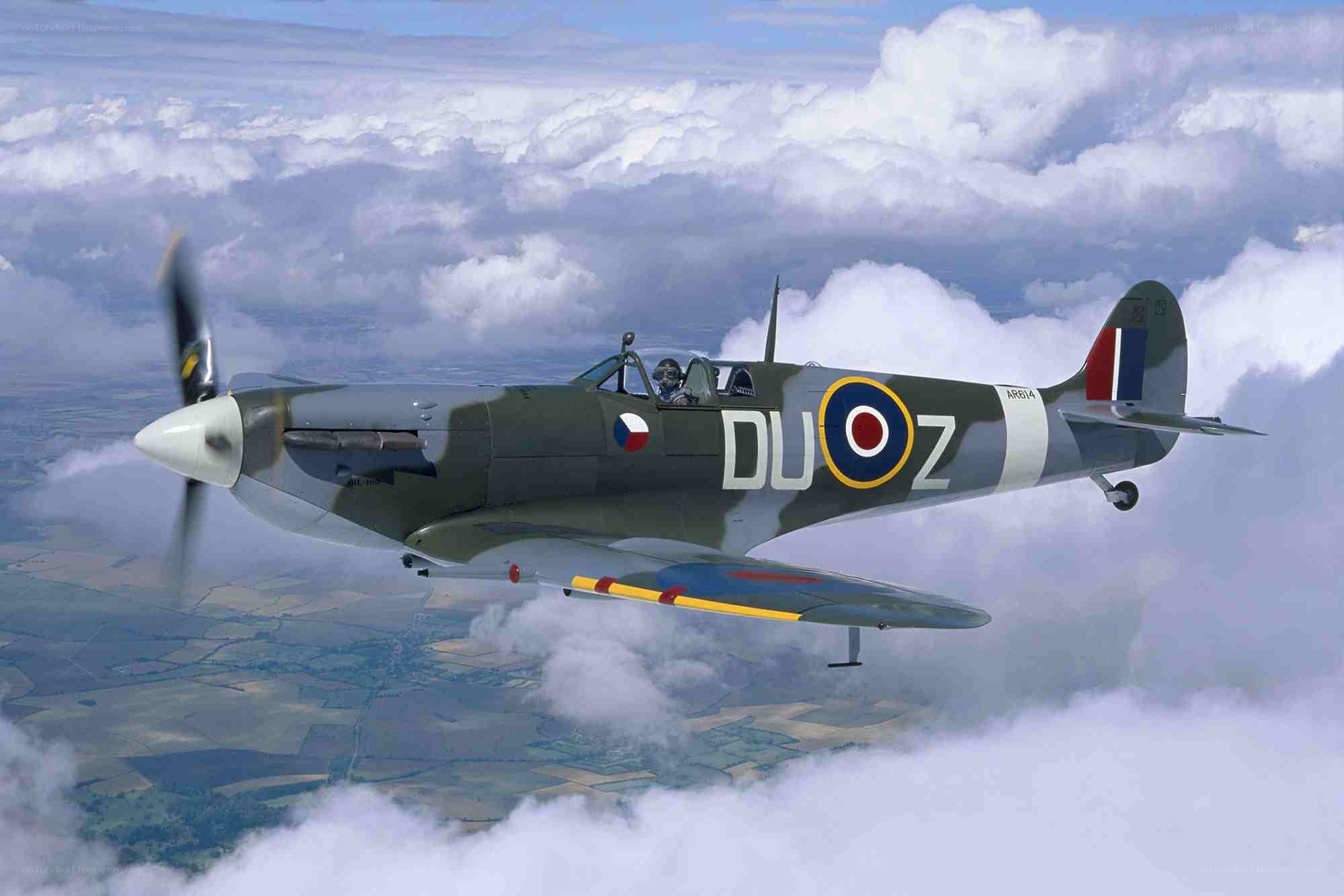 Spitfire in flight over clouds