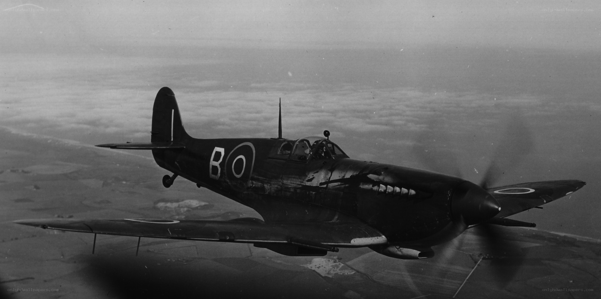 Spitfire in flight over clouds
