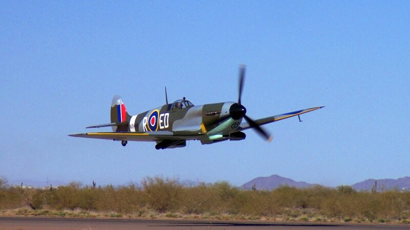 Spitfire in flight over desert