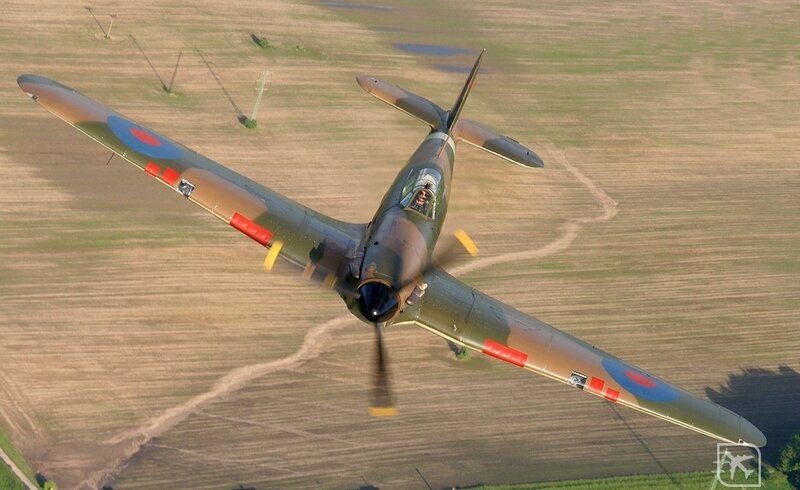Spitfire in flight over fields