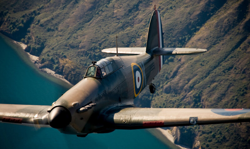 Spitfire in flight over mountains