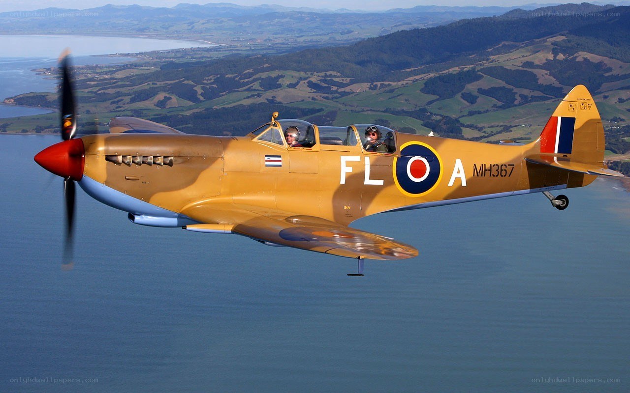 Spitfire in flight over water