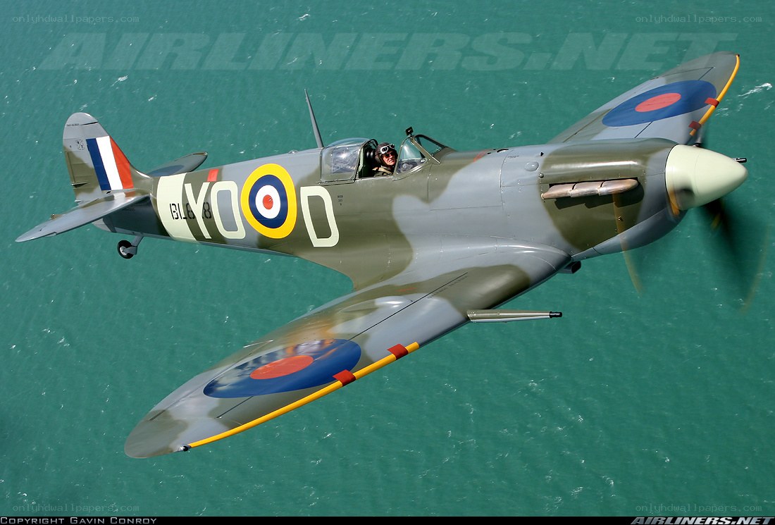 Spitfire in flight over water