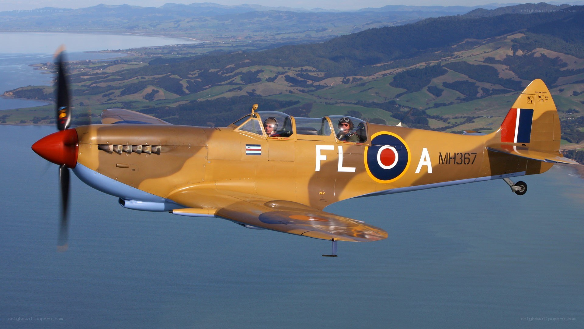 Spitfire in flight over water