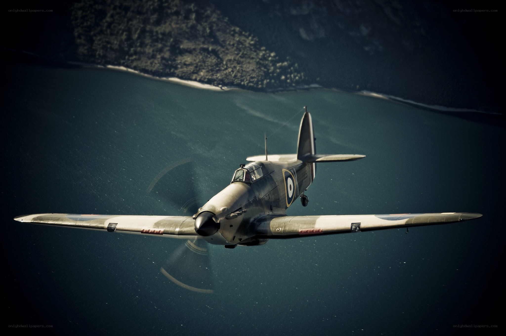 Spitfire in flight over water