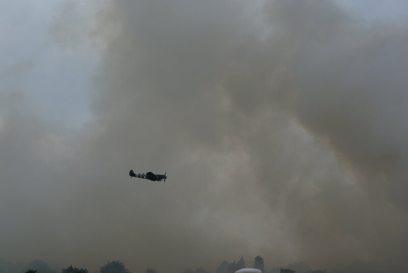 Spitfire in smoky sky