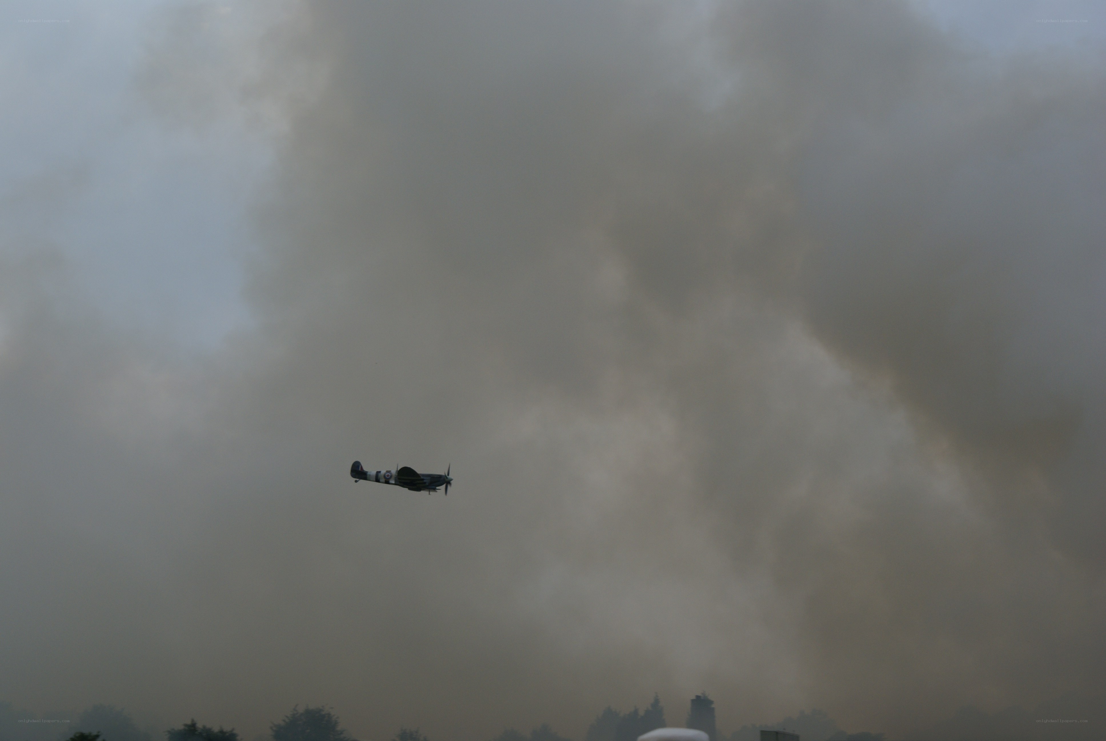 Spitfire in smoky sky