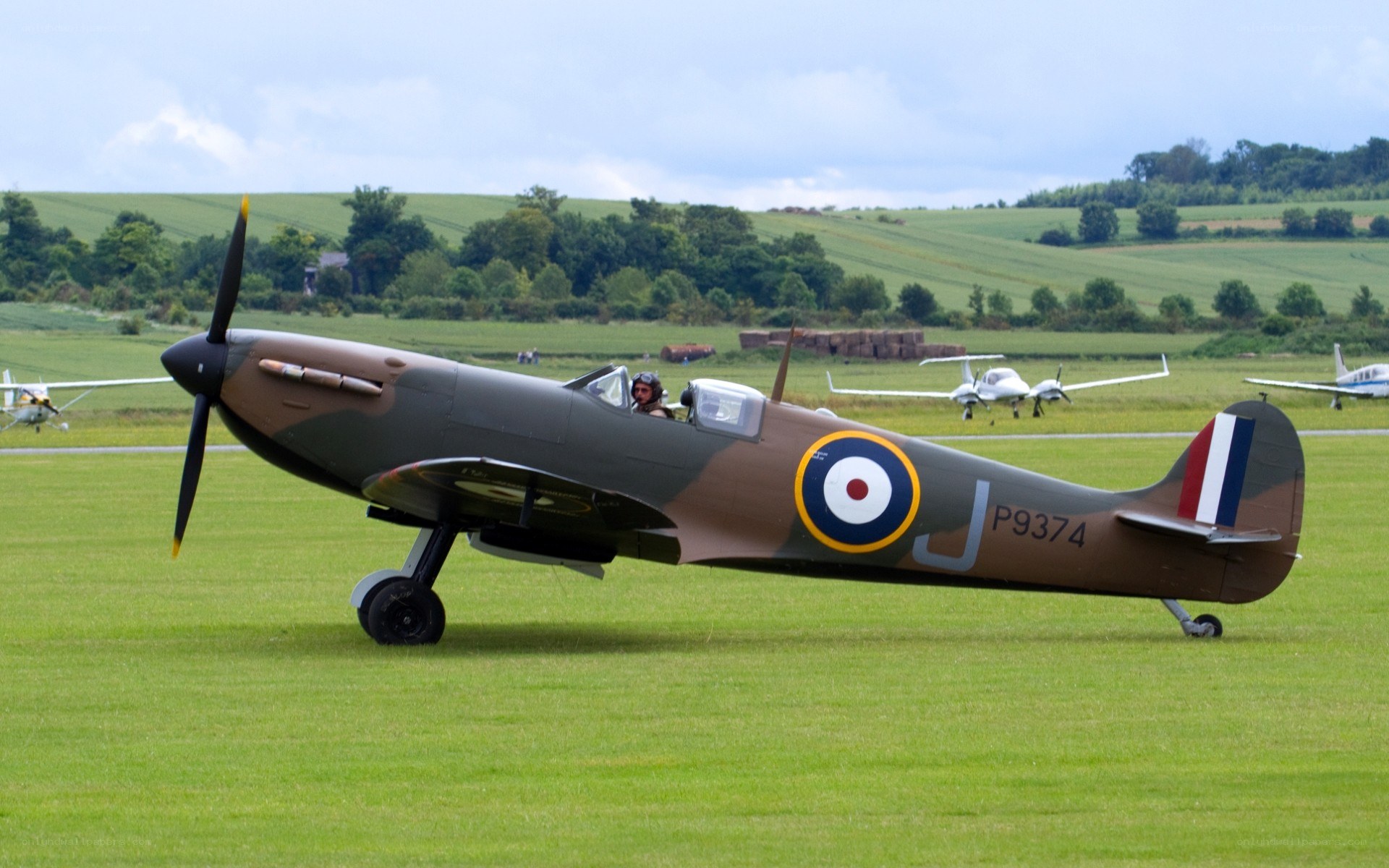 Spitfire on a grass airfield