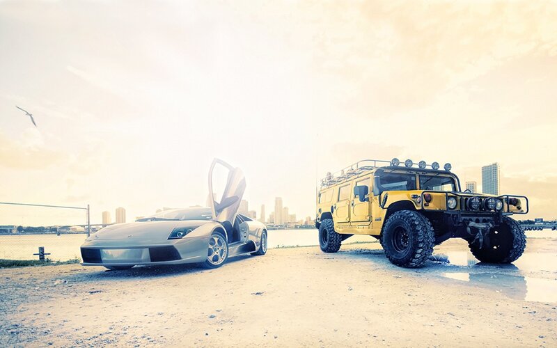 Sports car and Hummer by the water