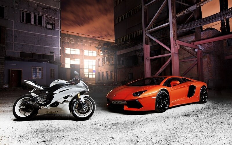 Sports car and motorcycle at night