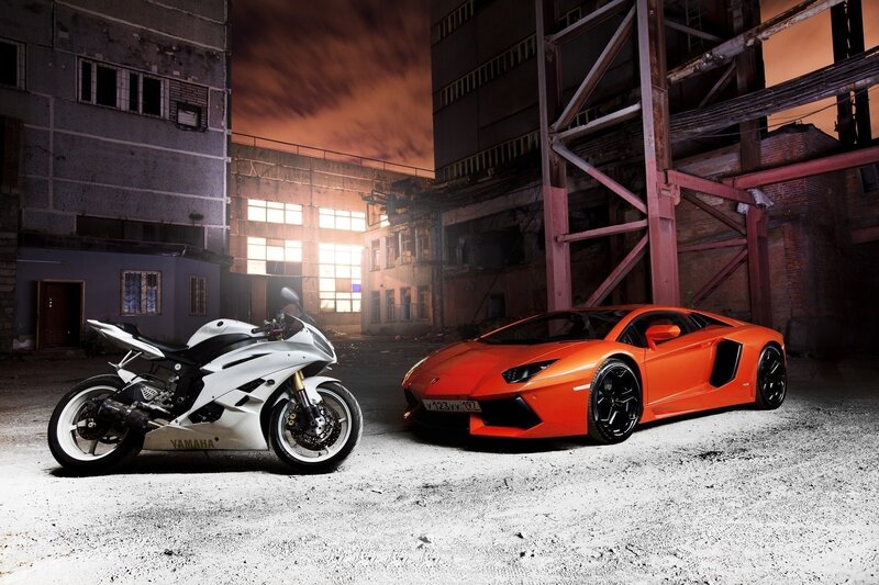 Sports car and motorcycle in warehouse