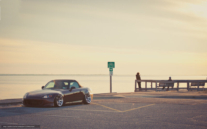 Sports car at sunset by the water