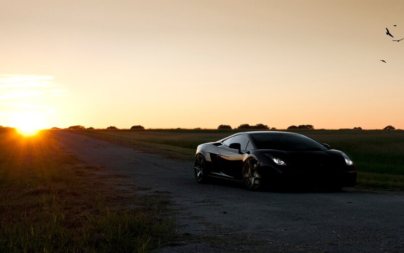 sports car at sunset on country road