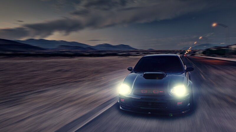 sports car driving at dusk