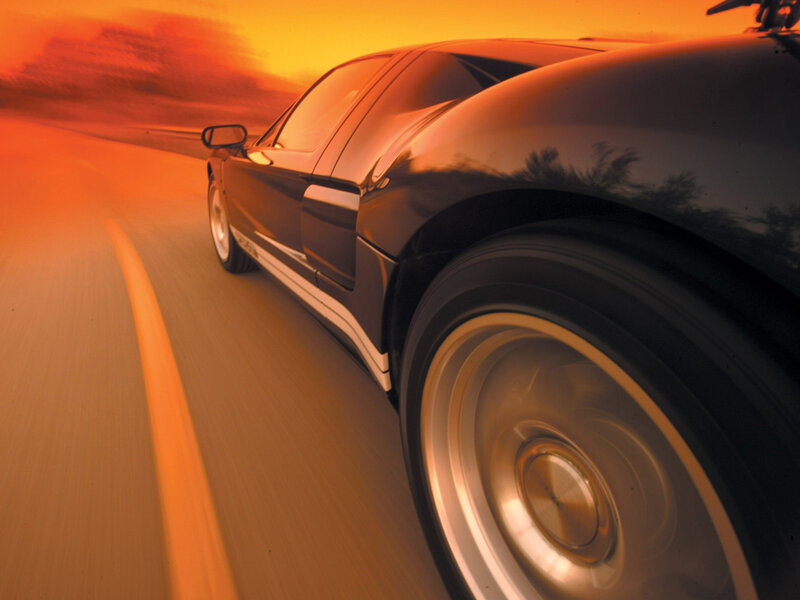 sports car driving at sunset
