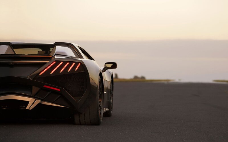 sports car on a road at sunset