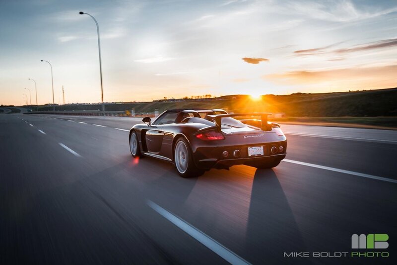 sports car on highway at sunset