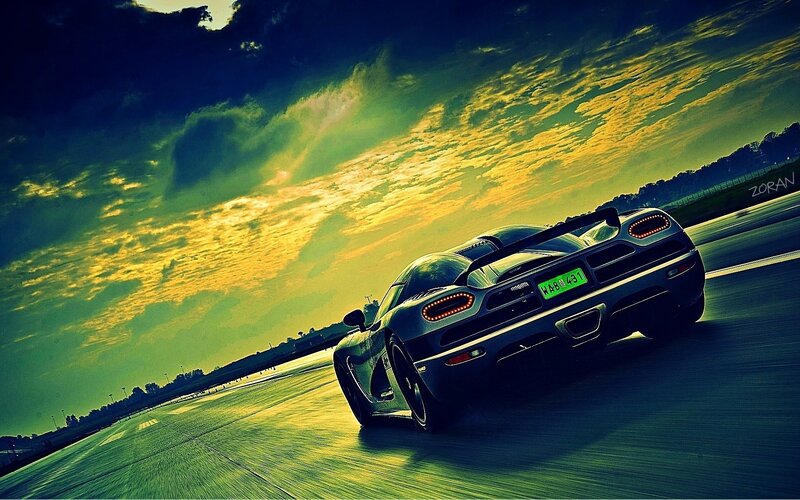 sports car on racetrack at sunset
