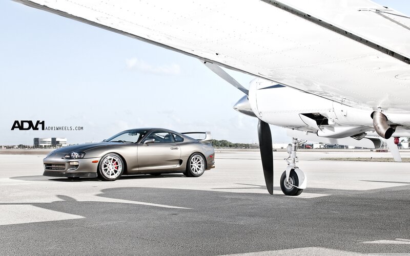 Sports car under airplane wing