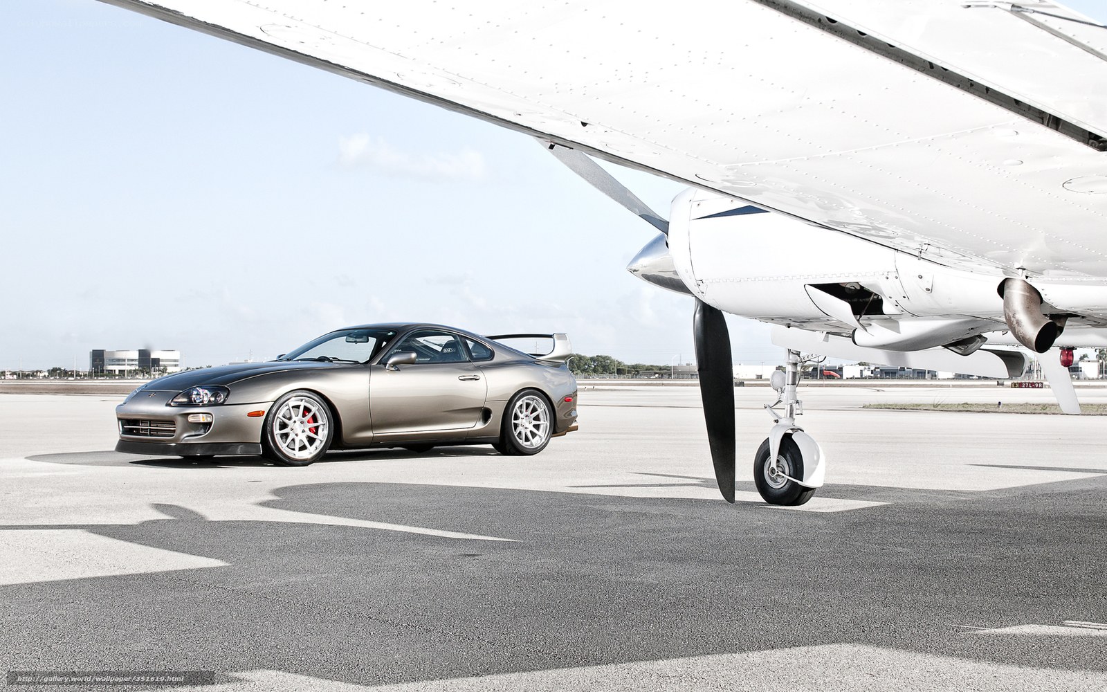 Sports car under airplane wing